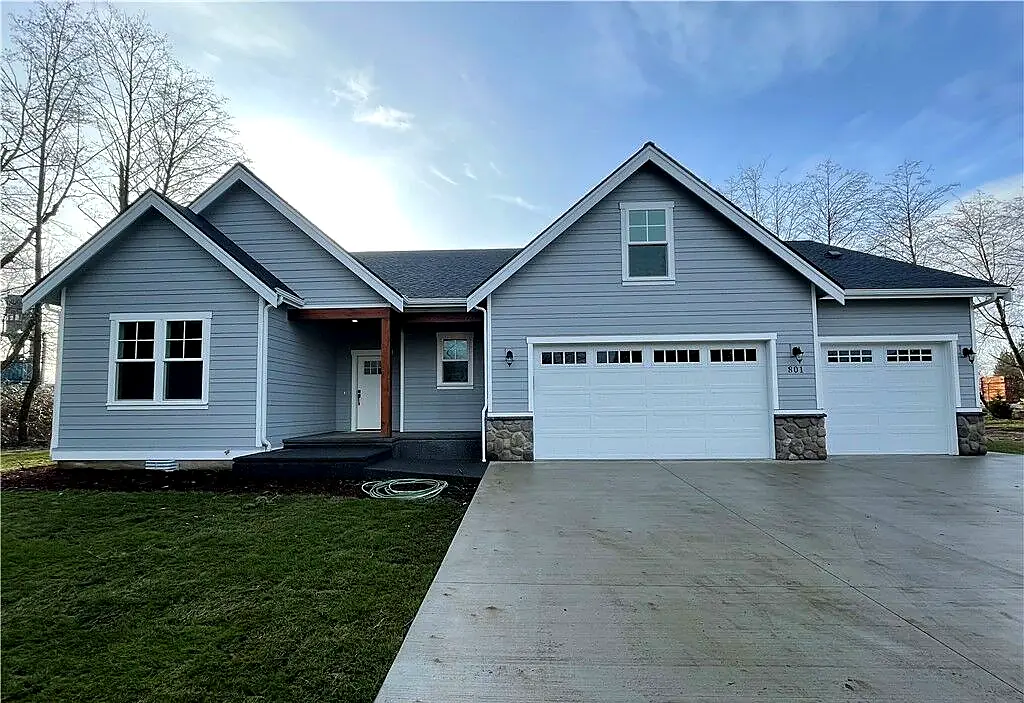 Completed gray home with three-car garage