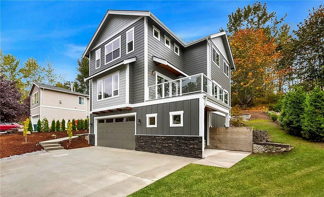 Completed hillside home with stone retaining wall